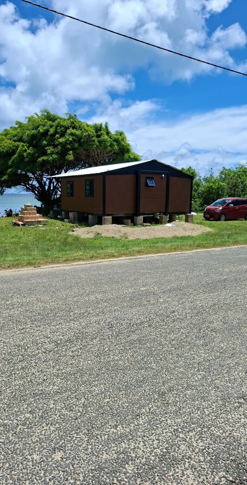 Delivered brown expandable home on a coastal lot.
